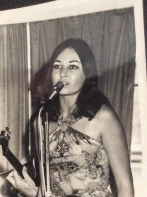 Ann singing at the microphone